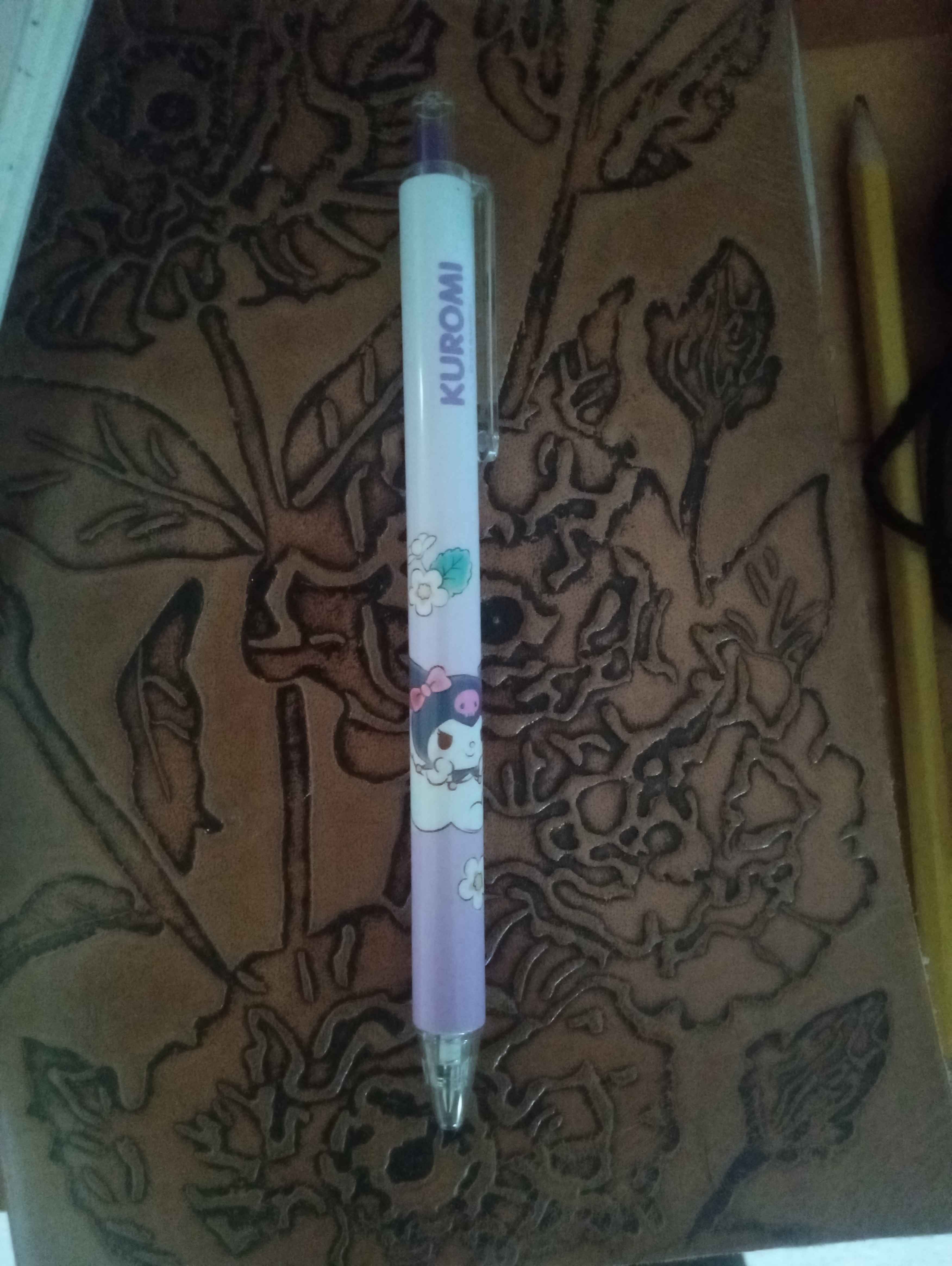 a purple pen with a picture of kuromi riding a cloud on it